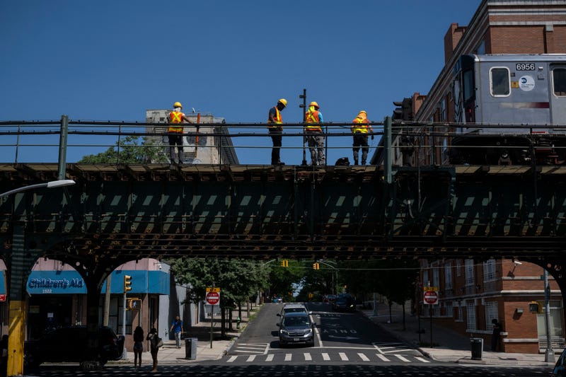 Workers repair a subway train platform in the Bronx on July 11, 2024