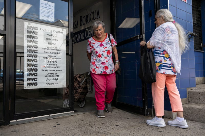 Senior citizens leave a cooling center during a summer heat wave in the Bronx borough of New York on July 11, 2024. 