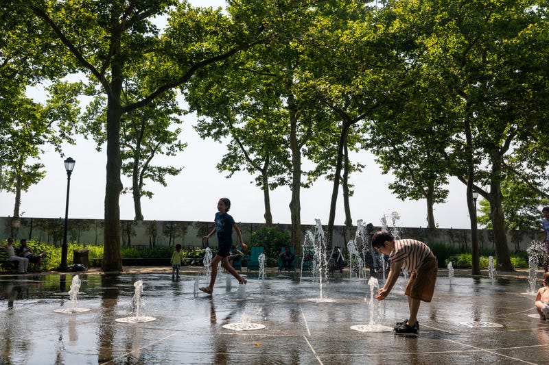 Children play in a fountain on a hot afternoon in Manhattan on July 8, 2024