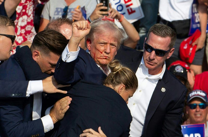 Republican candidate Donald Trump is seen with blood on his face surrounded by Secret Service agents as he is taken off the stage at a campaign event at Butler Farm Show Inc. in Butler, Pennsylvania, July 13, 2024. 