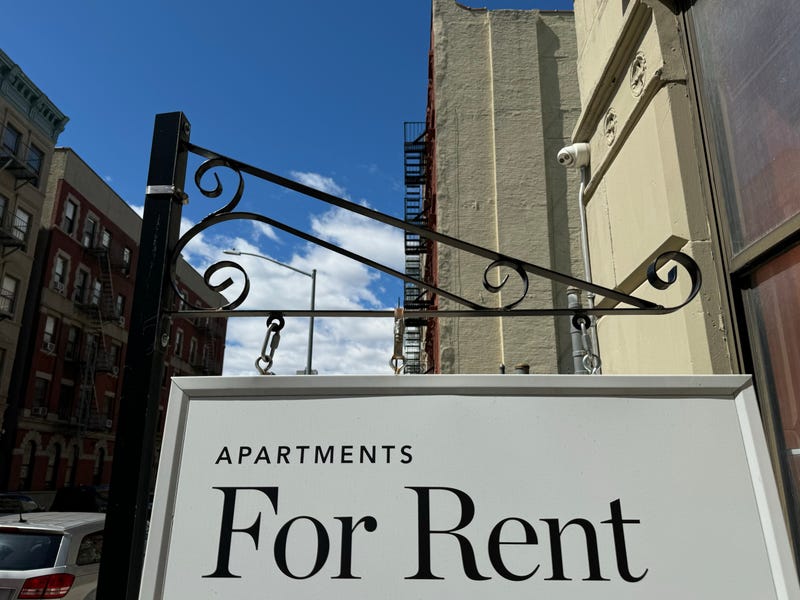 "Apartments for Rent" shingle hanging from a residential building in Harlem.