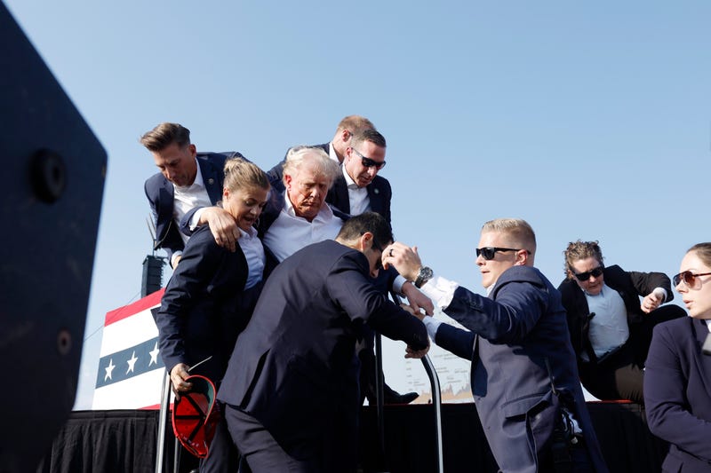 Republican presidential candidate former President Donald Trump is rushed offstage during a rally on July 13, 2024 in Butler, Pennsylvania.