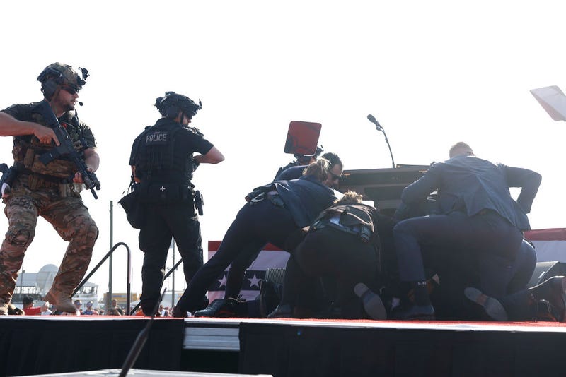 Republican presidential candidate former President Donald Trump is rushed offstage during a rally on July 13, 2024 in Butler, Pennsylvania. 