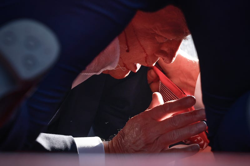 Republican presidential candidate former President Donald Trump is shown covered by U.S. Secret Service agents after an attempted assassination during a rally on July 13, 2024, in Butler, Pa.