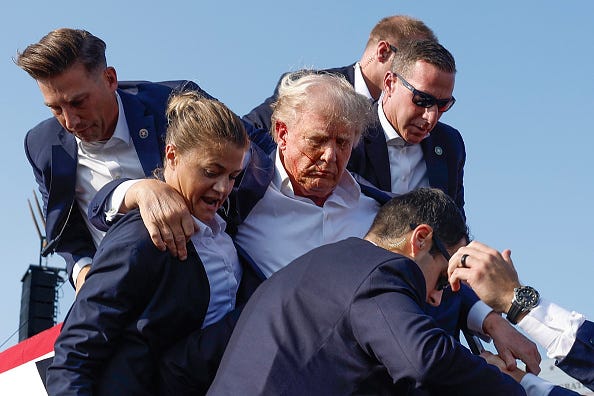 Republican presidential candidate former President Donald Trump is rushed offstage by U.S. Secret Service agents after being grazed by a bullet during a rally on July 13, 2024 in Butler, Pennsylvania.