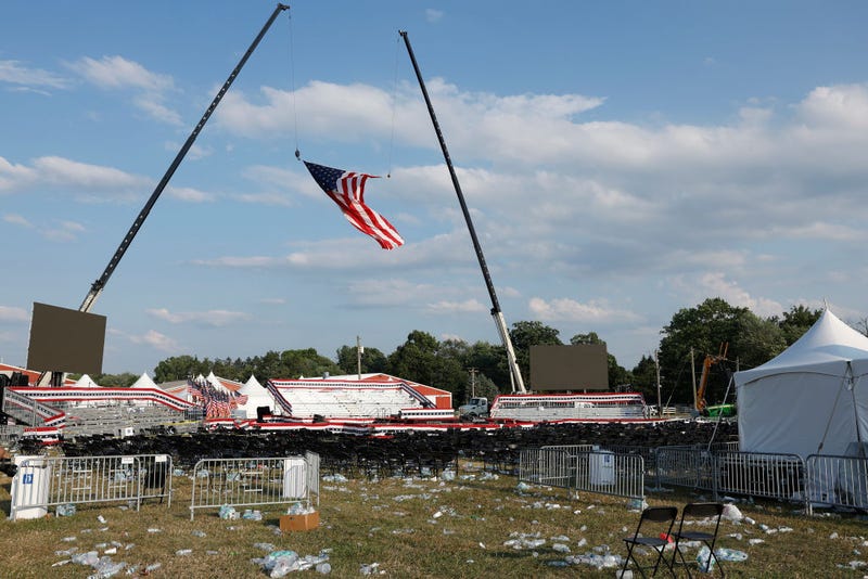 Campaign signs and empty water bottles are seen on the ground of a campaign rally for Republican presidential candidate former President Donald Trump on July 13, 2024 in Butler, Pennsylvania. According to Butler County District Attorney Richard Goldinger, the suspected gunman is dead after injuring former President Trump