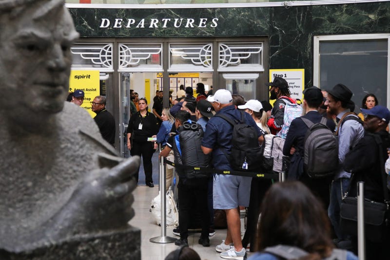 People wait for their flight after a global technology outage at LaGuardia Airport in the Queens borough of New York on July 19, 2024.