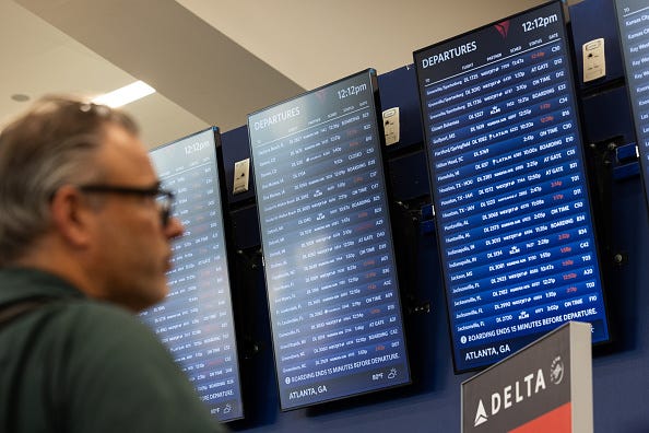Delta Airlines flights status are displayed for passengers at Hartsfield-Jackson Atlanta International Airport on July 22, 2024 in Atlanta, Georgia. 