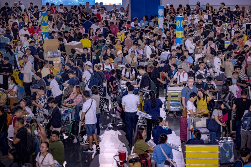 Long queues of passengers form at the check-in counters at Ninoy Aquino International Airport, amid a global IT disruption caused by a Microsoft outage and a Crowdstrike IT problem, on July 19, 2024 in Manila, Philippines