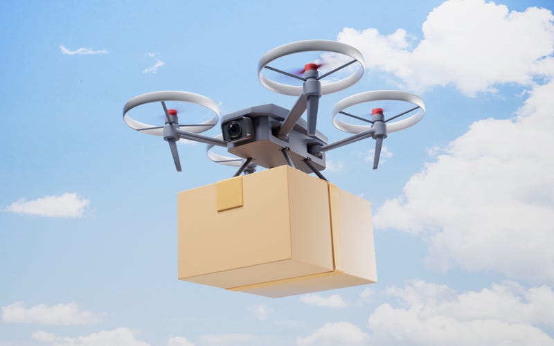 A flying drone carrying a package