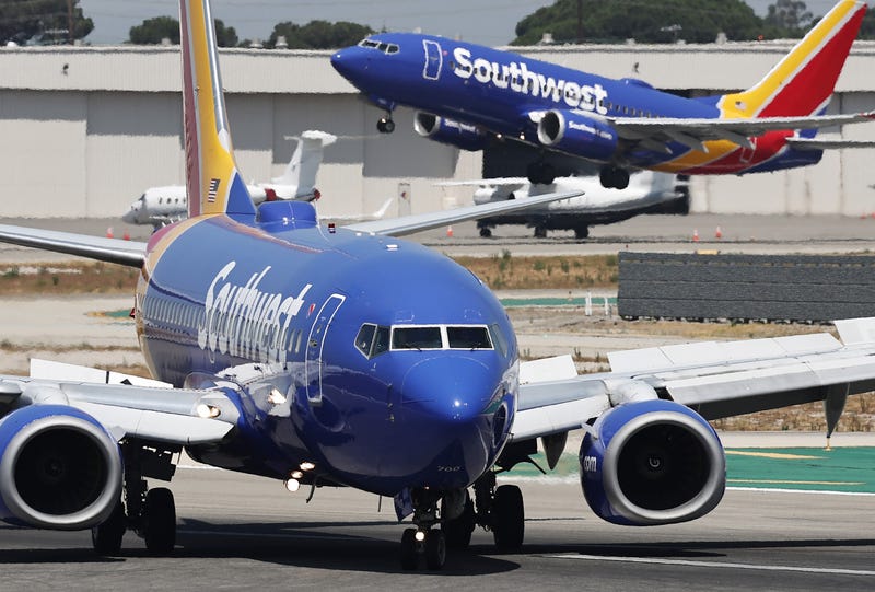 A Southwest Airlines plane takes off from Hollywood Burbank Airport as another Southwest plane taxis.