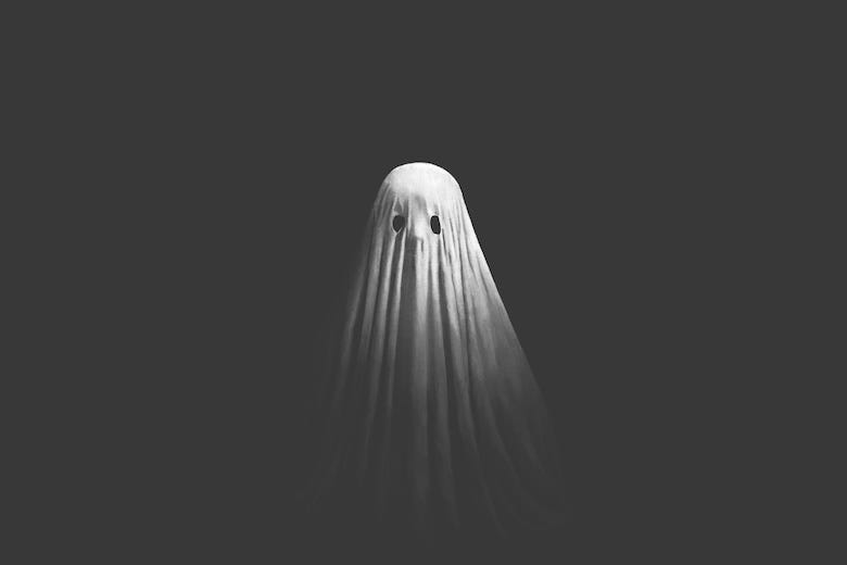 Illustration of a white ghost appearing from the black darkness,