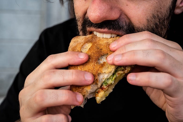 Man biting sandwich