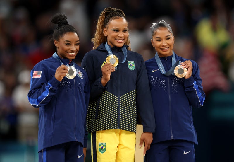 Gold medalist Rebeca Andrade, center, of Team Brazil; silver medalist Simone Biles, left, of Team United States; and bronze medalist Jordan Chiles, right, of Team United States pose on the podium during the 2024 Summer Olympics in Paris. Chiles has been stripped of her bronze medal.