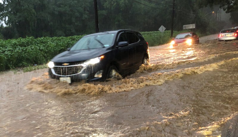 A car drives through flooding on Route 107 and and Chicken Valley Road in Old Brookville, Nassau County, on August 6, 2024