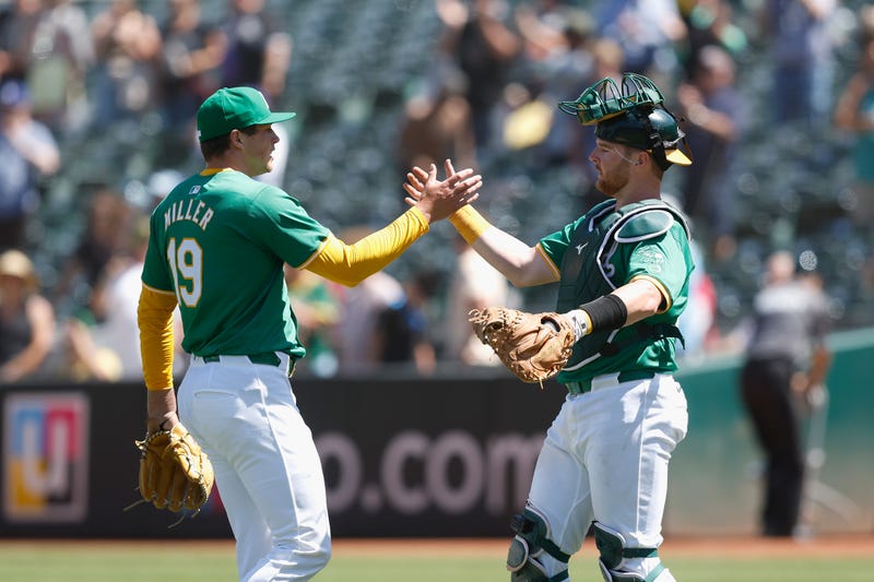 Pitcher Mason Miller #19 and catcher Kyle McCann #52 of the Oakland Athletics celebrate a 3-2 win against the Chicago White Sox at Oakland Coliseum on August 07, 2024 in Oakland, California.