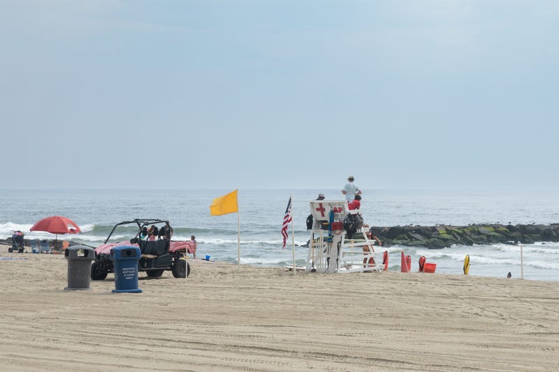 Asbury Park, New Jersey - July 29, 2024: Lifeguards sit on the lifeguard stand keeping swimmers safe.