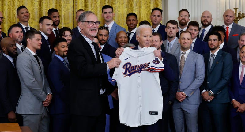 Texas Rangers Manager Bruce Bochy (L) presents U.S. President Joe Biden with a team jersey during an event to celebrate the team's Major League Baseball 2023 World Series Championship in the East Room at the White House on Aug. 8, 2024, in Washington, DC.