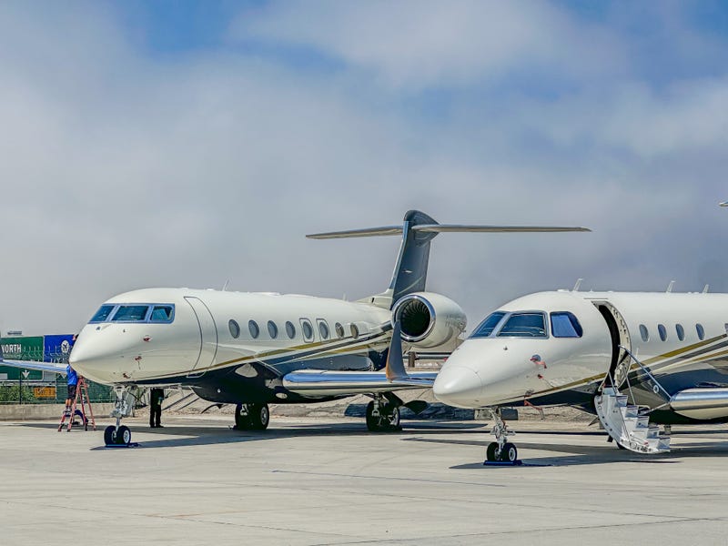 Corporate jets sit on airport tarmac