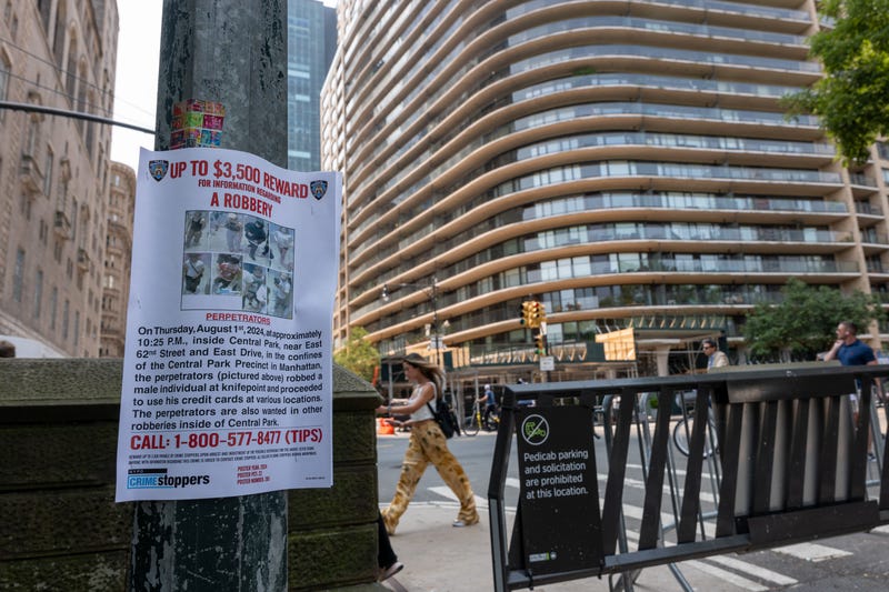 A "wanted" poster is displayed on August 15, 2024, near Central Park South, where the NYPD has set up a staging area following a series of muggings at the park