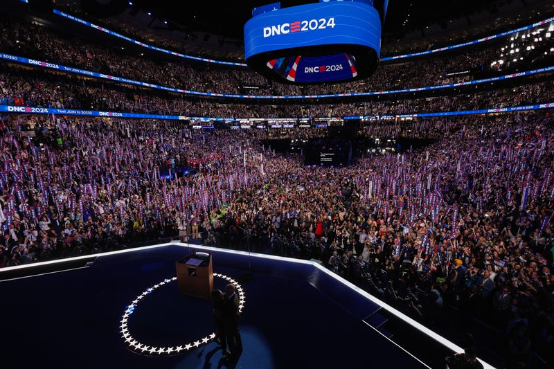 Former U.S. First Lady Michelle Obama greets former President Barack Obama onstage on Day Two of the Democratic National Convention at the United Center
