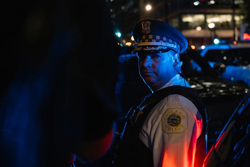 A Chicago Police Officer standing in evening shadows
