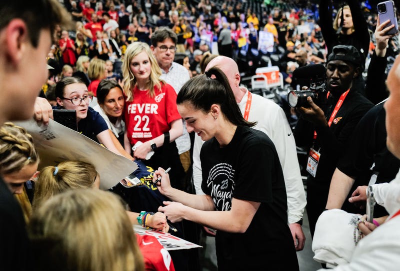 Caitlin Clark #22 of the Indiana Fever signs autographs before the game against the Minnesota Lynx at Target Center on August 24, 2024 in Minneapolis, Minnesota. Moore's jersey will be retried by the Lynx after the game.