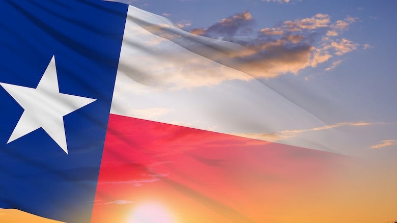 The Texas state flag waving amongst the clouds