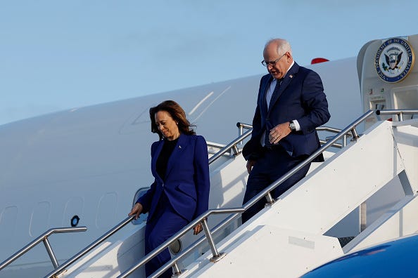 Democratic presidential candidate, U.S. Vice President Kamala Harris and vice presidential candidate Minnesota Gov. Tim Walz walk off Air Force 2 at the Milwaukee Mitchell International Airport on August 20, 2024 in Milwaukee, Wisconsin. 
