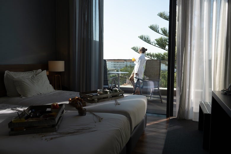 Woman standing on the balcony of her luxury hotel
