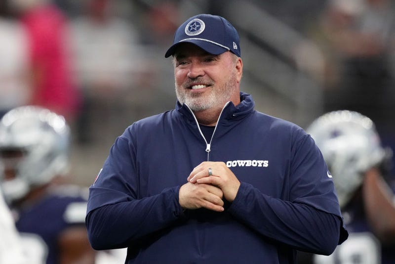 Mike McCarthy smiling on sidelines