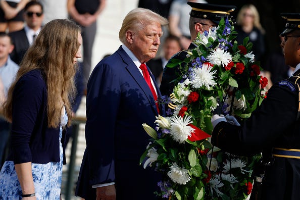 Republican presidential nominee, former U.S. President Donald Trump stands alongside Misty Fuoco, whose sister Sgt. Nicole Gee died in Abbey Gate Bombing, at a wreath laying ceremony at the Tomb of the Unknown Soldier at Arlington National Cemetery on August 26, 2024 in Arlington, Virginia. 