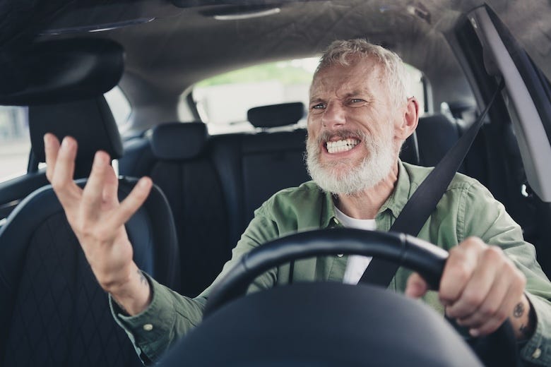 Irritated man driving a car