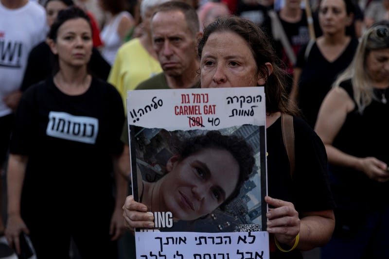 A protester holds a photo of slain hostage Carmel Gat, killed in captivity in Gaza during a rally calling for an immediate hostage deal and release of hostages held by Hamas in the Gaza Strip on Sept. 2, 2024, in Tel Aviv, Israel.