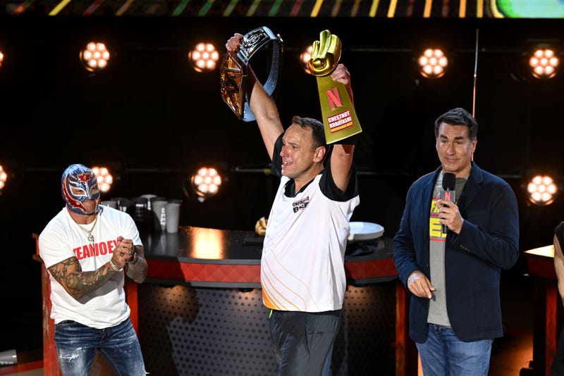 Joey Chestnut, Rey Mysterio and Rob Riggle