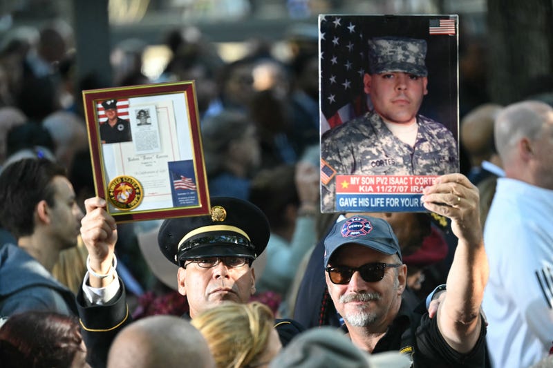 People attend a remembrance ceremony on the 23rd anniversary of the September 11 terror attacks