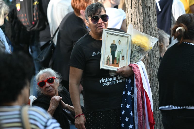 People attend a remembrance ceremony on the 23rd anniversary of the September 11 terror attacks