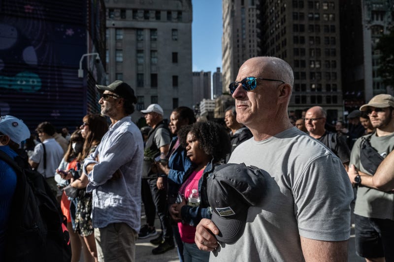 People gather outside of the perimeter of the 9/11 memorial site for a moment of silence on September 11, 2024 in New York City