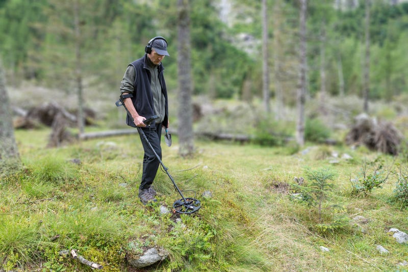 A British treasure hunter is being credited with uncovering what may be the largest collection of Roman coins ever found in Wales - and he guarded them for three days by sleeping in his car.