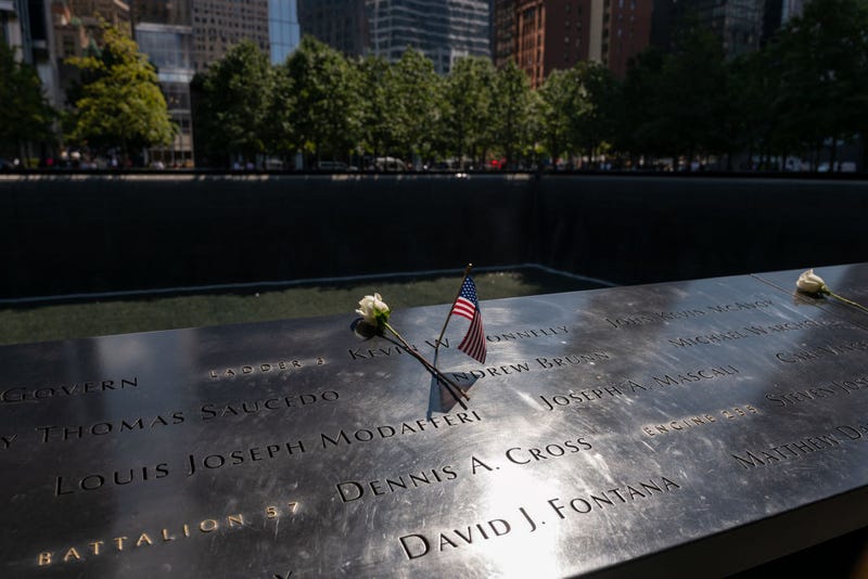 A flower and American flag are placed at the September 11 Memorial and Museum, which is located on the land where the Twin Towers once stood before they were destroyed in the attacks on Sept. 11, 2001.