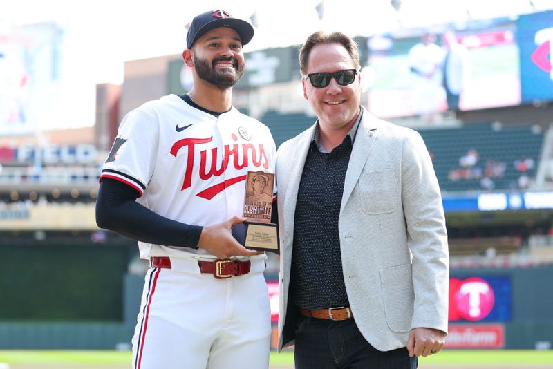 Twins pitcher Pablo López (L) with Twins President of Baseball and Business Operations Derek Falvey (R) at Target Field on September 15, 2024 in Minneapolis, Minnesota. 