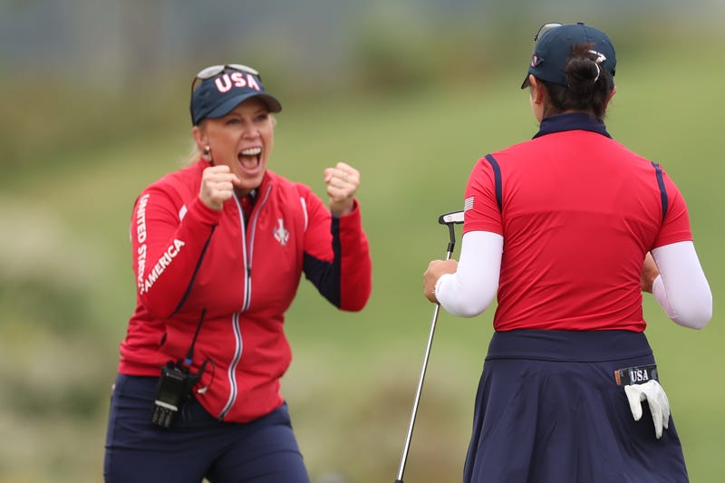 Assistant Captain Morgan Pressel reacts with Rose Zhang of Team United States after her winning putt on the 16th green during the Friday Foursomes matches against Team Europe during the first round of the Solheim Cup 2024 at Robert Trent Jones Golf Club on September 13, 2024 in Gainesville, Virginia.