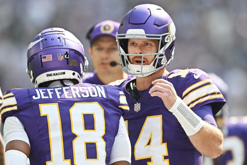 Quarterback Sam Darnold #14 and Justin Jefferson #18 of the Minnesota Vikings celebrate after their touchdown connection against the Houston Texans during the first quarter at U.S. Bank Stadium on September 22, 2024 in Minneapolis, Minnesota.
