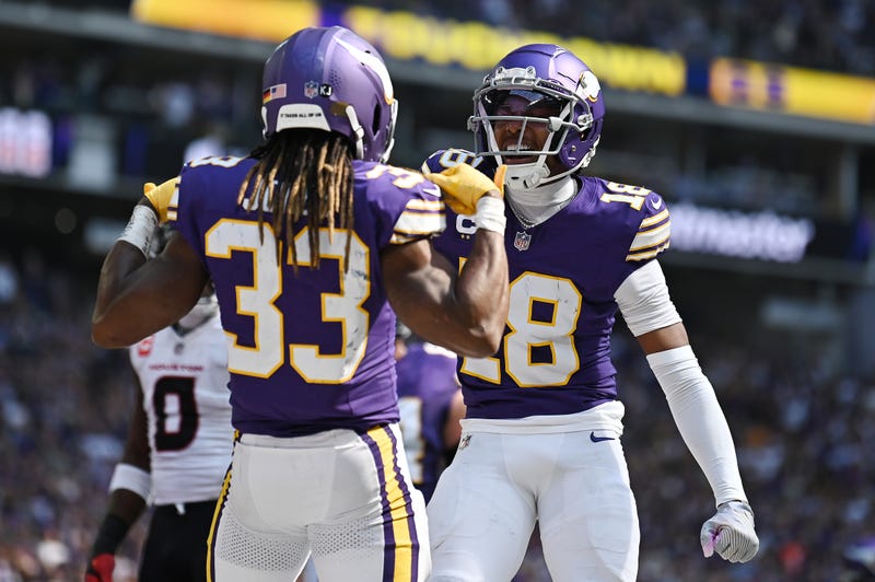Aaron Jones #33 of the Minnesota Vikings celebrates his receiving touchdown with Justin Jefferson #18 during the first quarter against the Houston Texans at U.S. Bank Stadium on September 22, 2024 in Minneapolis, Minnesota.