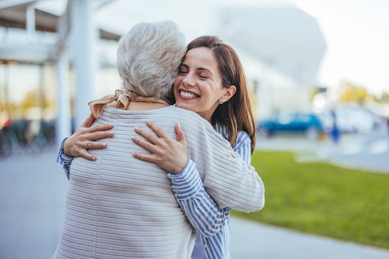Adult woman hugging her grandmother
