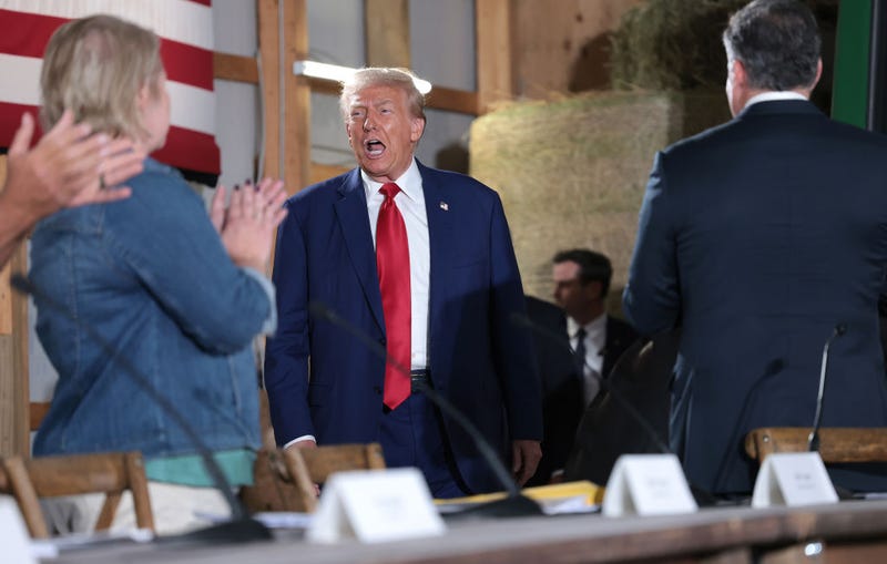 Republican presidential nominee, former U.S. President Donald Trump, (C) greets attendees during a campaign stop to address Pennsylvanians who are concerned about the threat of Communist China to U.S. agriculture at the Smith Family Farm September 23, 2024 in Smithton, Pennsylvania.