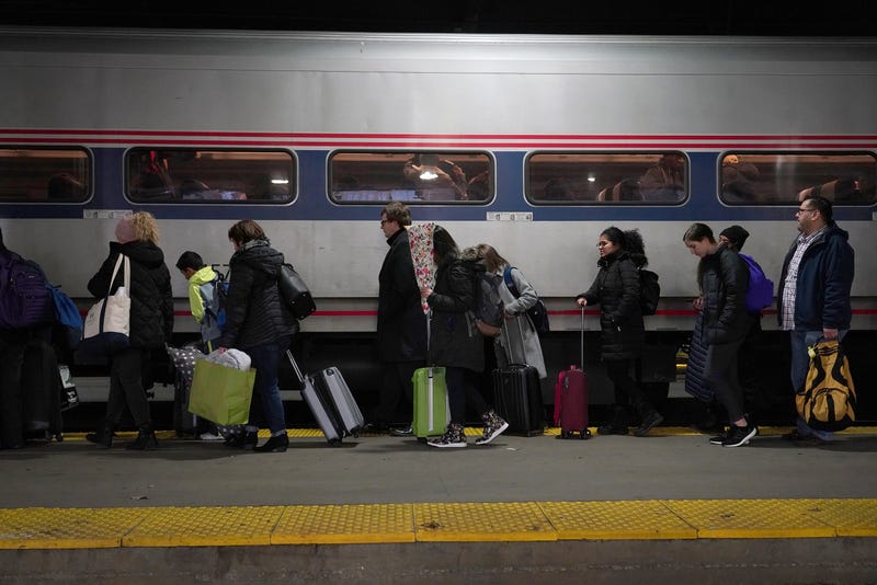 Travelers board an Amtrak train at Chicago's Union Station