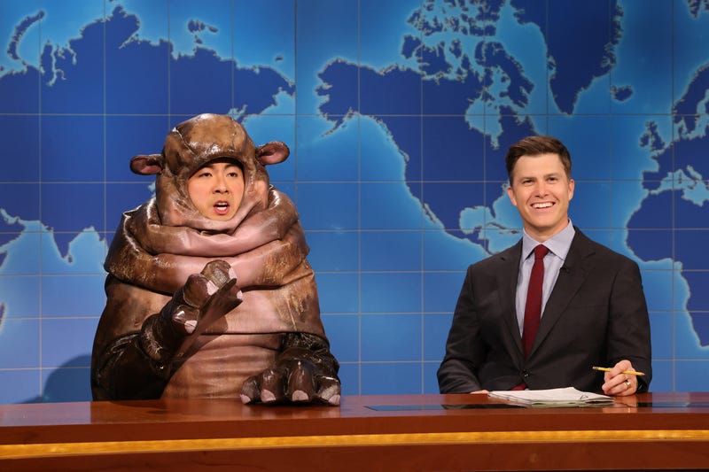 Bowen Yang dressed as Moo Deng the hippo and Colin Jost during "Weekend Update" on "Saturday Night Live" on Sept. 28, 2024.