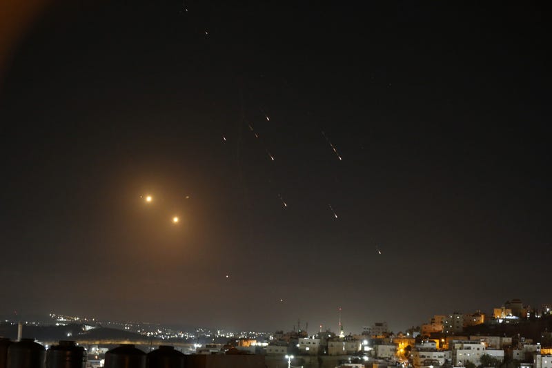 Rockets, fired from Iran, are seen over Jerusalem from Hebron, West Bank, on Oct. 1.