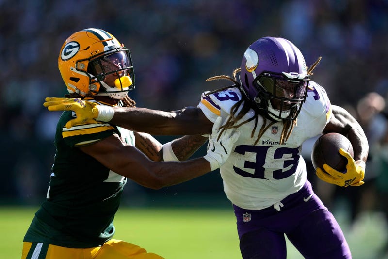 Aaron Jones #33 of the Minnesota Vikings carries the ball against Eric Stokes #21 of the Green Bay Packers during the second half of the game at Lambeau Field on September 29, 2024 in Green Bay, Wisconsin.